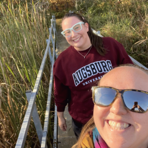 Amanda and Ellen outdoors on a bridge.