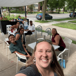 The CCV team along with Hannah Sackett out for lunch outside at two tables. 