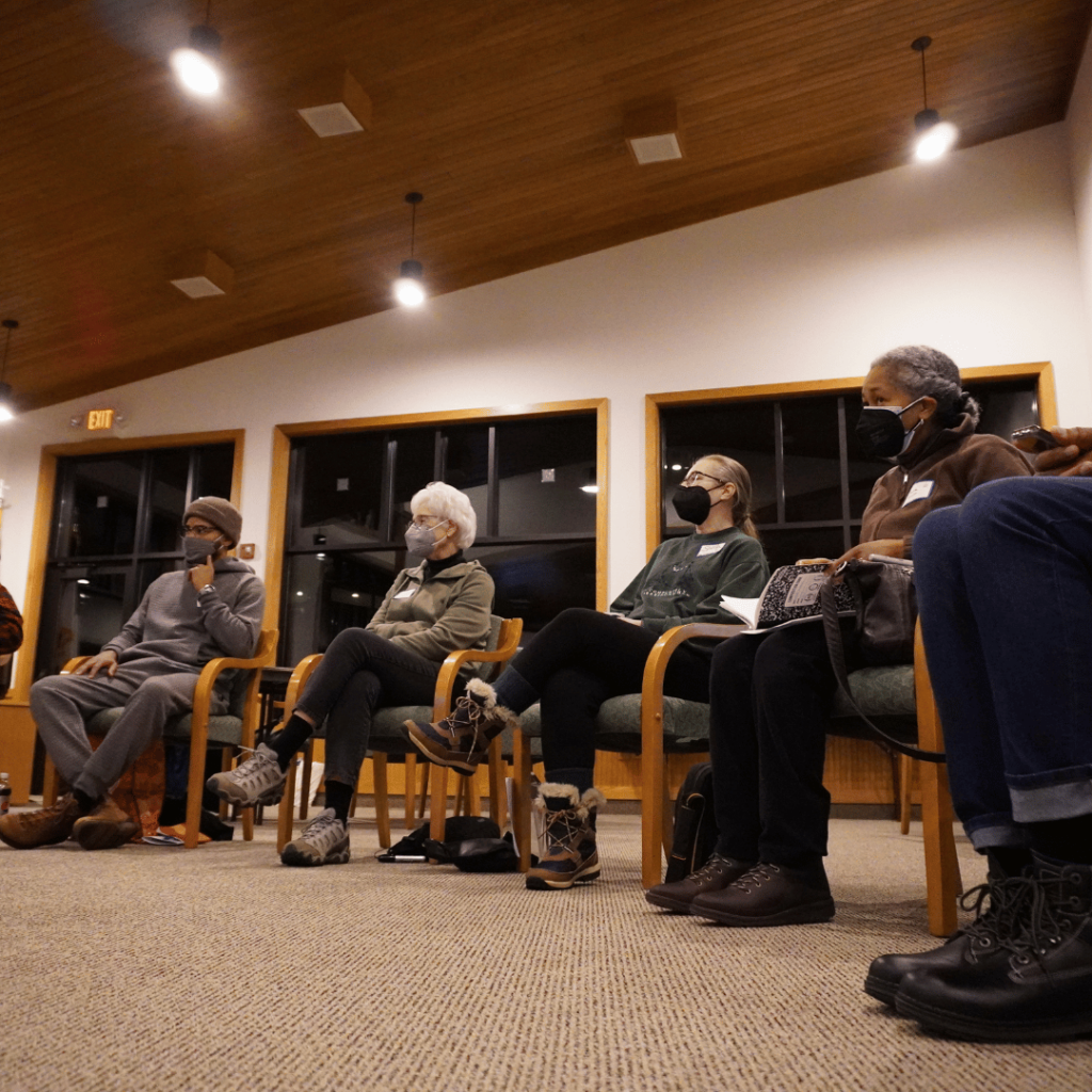 5 team leads sitting in a circle on chairs