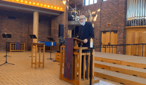 Mark Hanson speaking at the podium in chapel