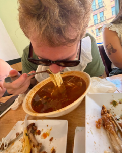 StepUP student eating noodles.