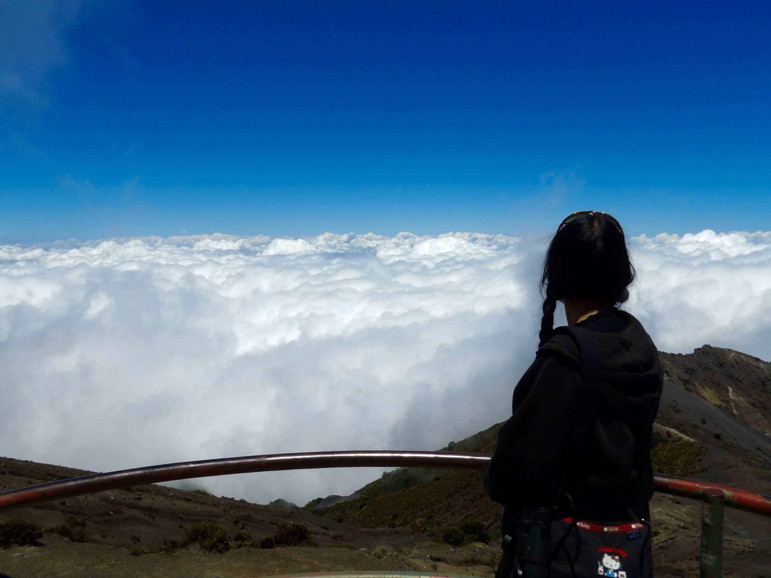 StepUP scholar looking down at the clouds from a mountain top