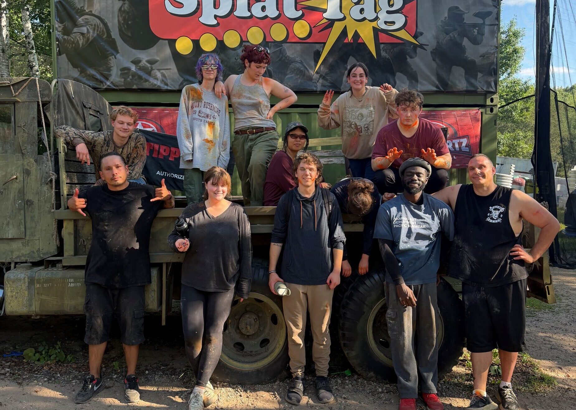 Photo of 16 stepup students in front of an army truck outside