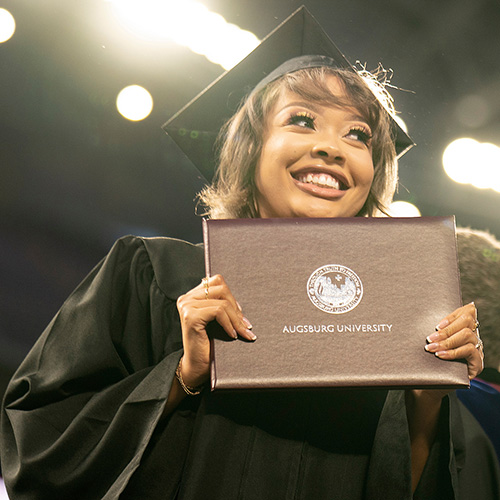A female student holder a diploma folder
