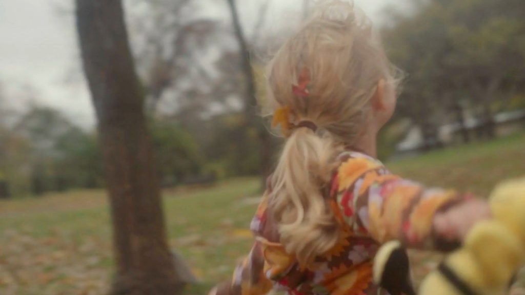 Girl playing in the leaves