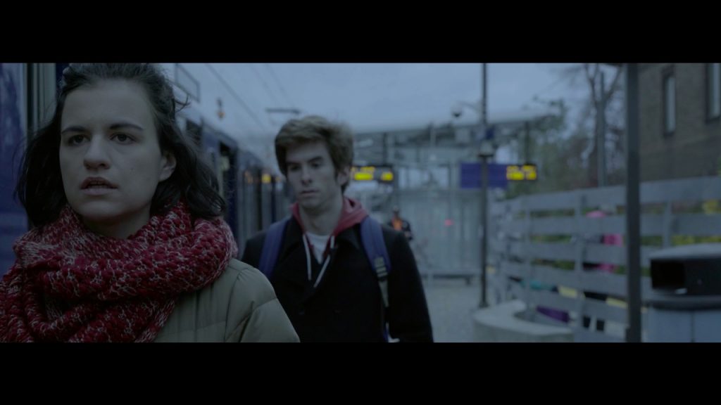 Characters walk after exiting the train [Still frame from the film]