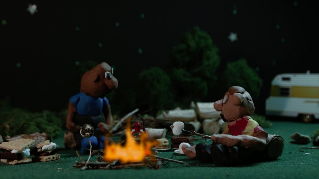 Rodney and Jimmy sitting around a campfire [Still image from the film]