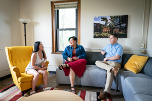 Three people talking together in a lounge here.