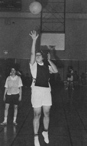 Patty shooting a basketball into the hoop during a game