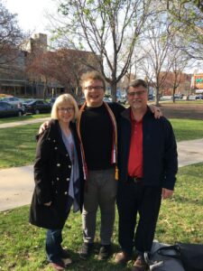 A photo of Jill, Gabe, and John at graduation