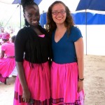 young women wear bright pink skirts and smile