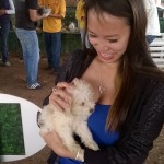 a young woman holds a small puppy