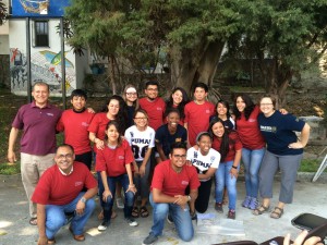 group poses in matching red shirts