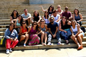 group of college students sit on large stone steps