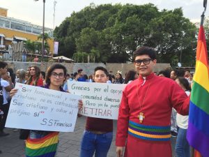 people march in parade holding signs