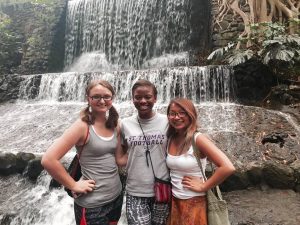 Three Students in front of Waterfalls