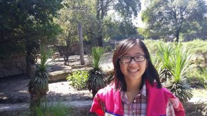 Student in front of floral scene