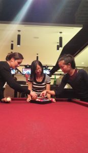 Students at a pool table