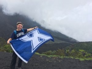 Girl with Xavier University flag at volcano