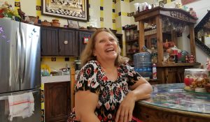 a woman sits in a kitchen