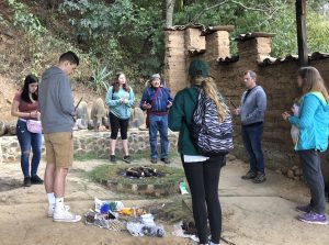 Students stand in a circle around a Guatemalan man speaking