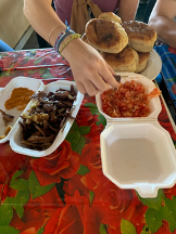 a table with two Styrofoam containers are half opened revealing a mixture of cooked beef