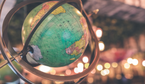 a globe in front of soft string of lights