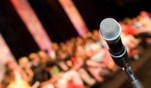 Microphone featured in front of a blurred audience in the background