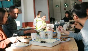 New international students enjoying lunch at Campus Cafe in Cedar Riverside.