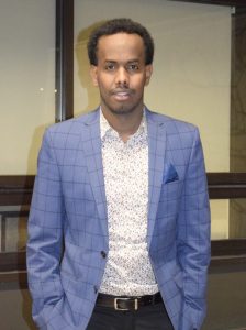 Man in a blue blazer with his hands in his pockets