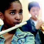 Image of young students playing band instruments