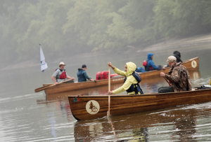 A group of Augsburg students canoeing on the Mississippi River