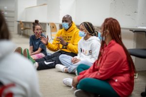 Jamil Stamschror-Lott '16 MSW leading a community healing session. | The New York Times