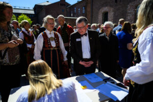 Paul Pribbenow and guests check in at an outdoor reception in Oslo, Norway.