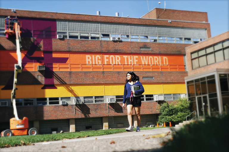 Side of Science Hall painted with "Small to our Students, Big for the World"