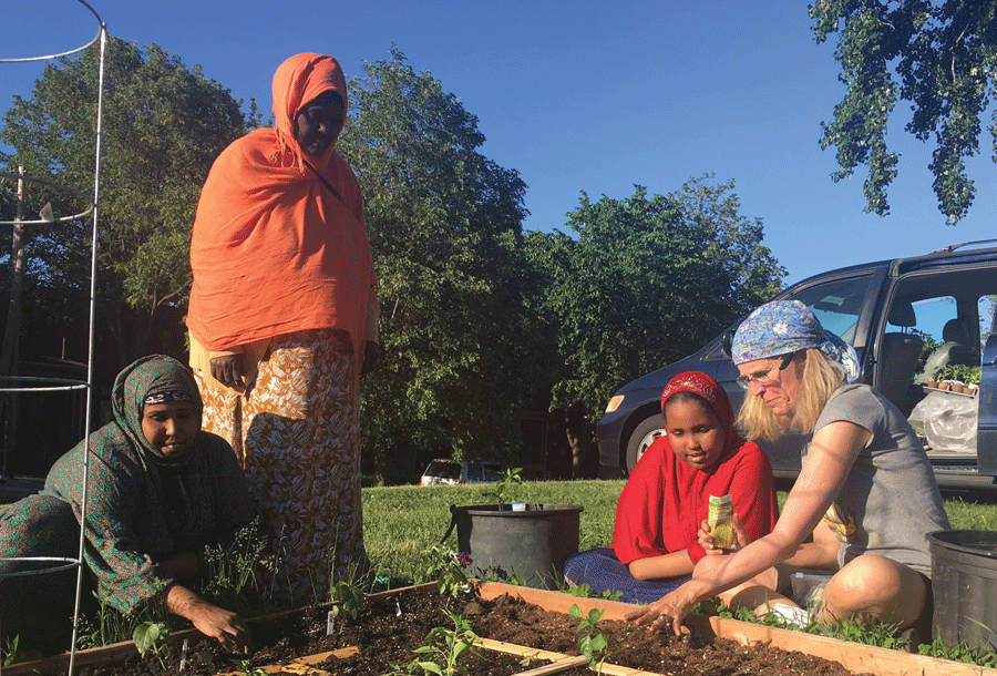 Neighbors planting in the community garden