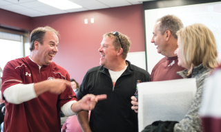 Four people engaging in a conversation and laughing