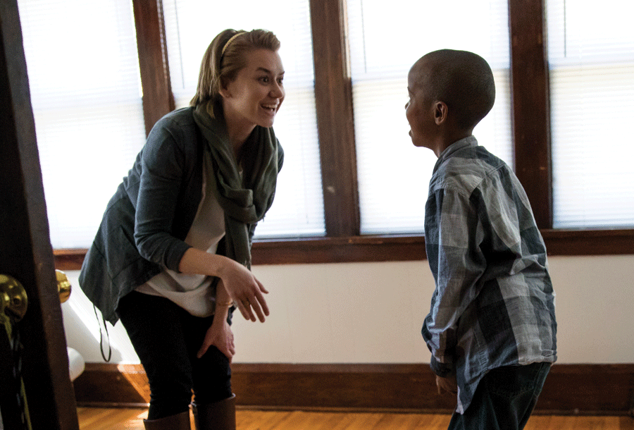 Katia Iverson ’12 encourages a new arrival from a refugee family as he practices his English.