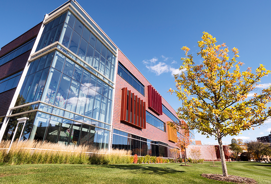 Augsburg newest building, Hagfors center reflecting the clouds in the sky and fall colors.