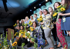 Peace Scholar students taking a group photo on stage