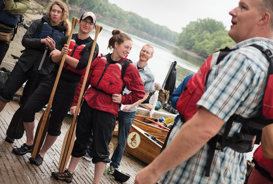 Students gathered on shore before going out on the river