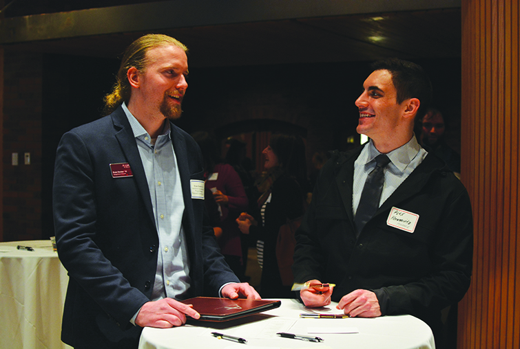 Two men at a networking event