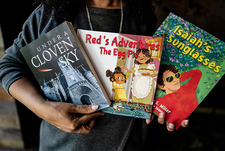 Mary Taris ’04 holding 3 of her books