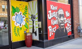 George Floyd painting mural with words "No justice No peace" 