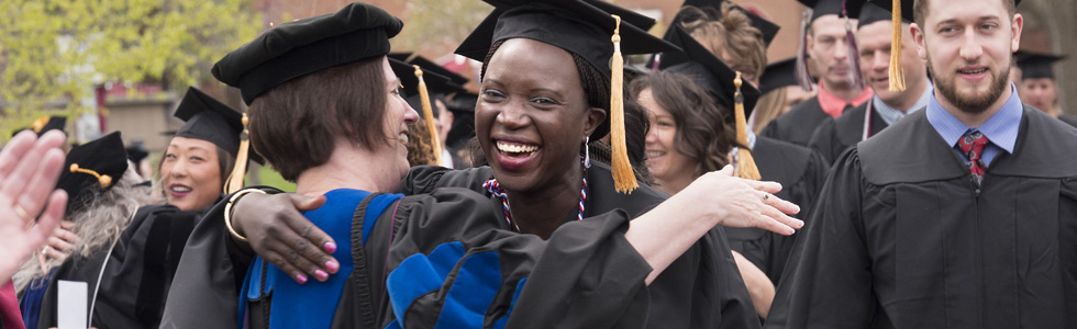 Graduate students hugging