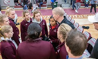 Coach speaking to a group of girls