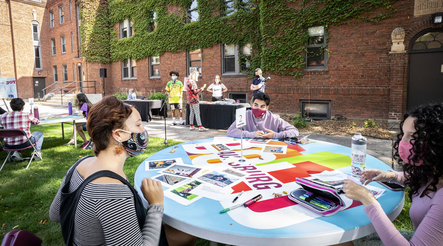 Augsburg-Fund-Header.2 Students in the quad working at a round table