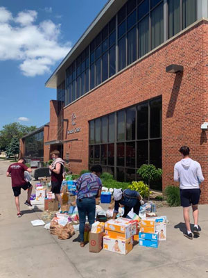 Students and staff collecting supples in front of Si Melby Hall