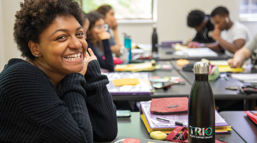 Student smiling at the camera in class