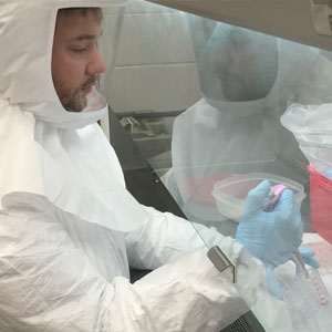 Will Matchett in a full lab suit testing